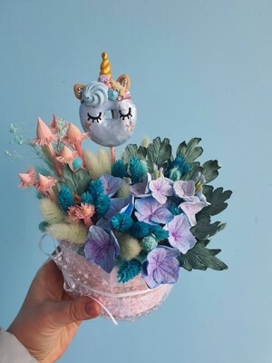 Composition of a blue unicorn made of handmade flowers