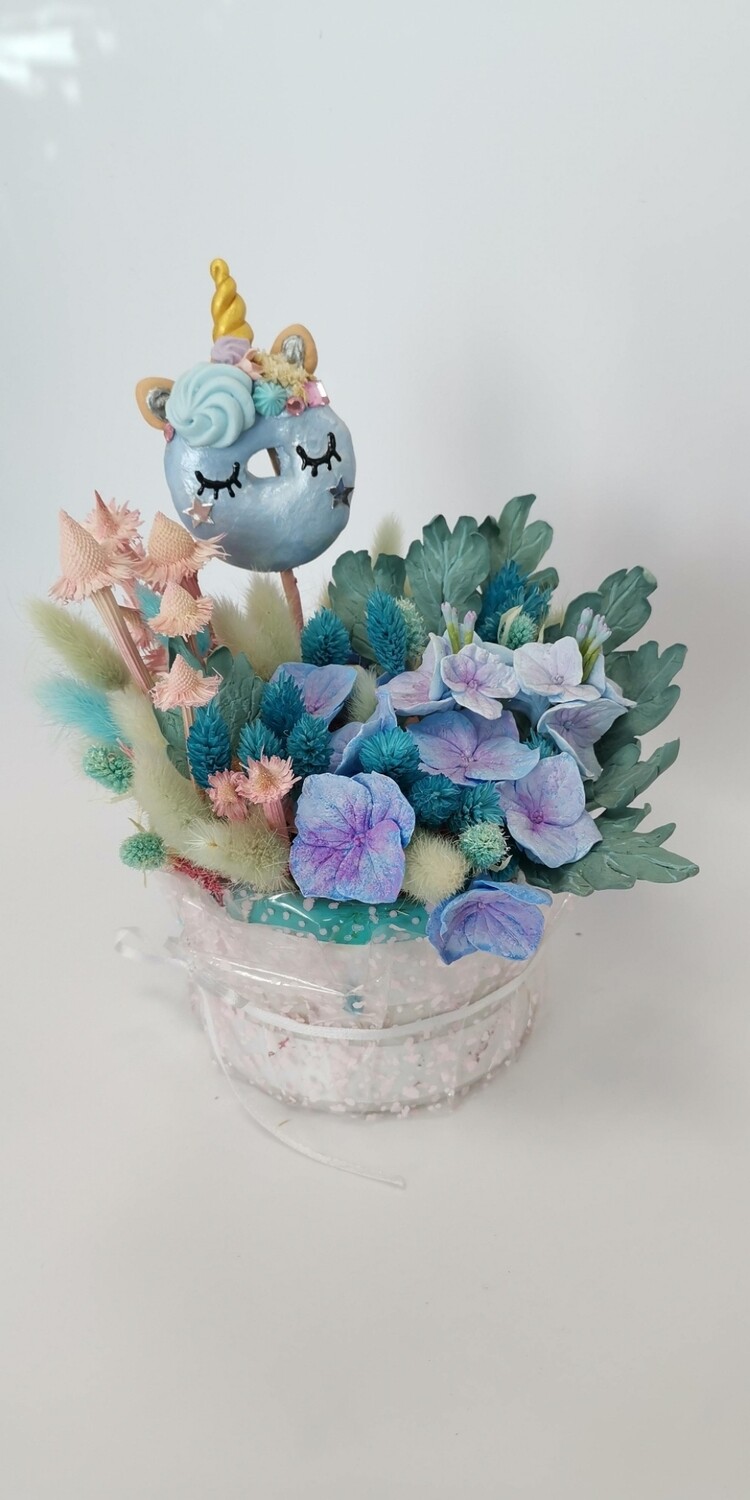 Composition of a blue unicorn made of handmade flowers