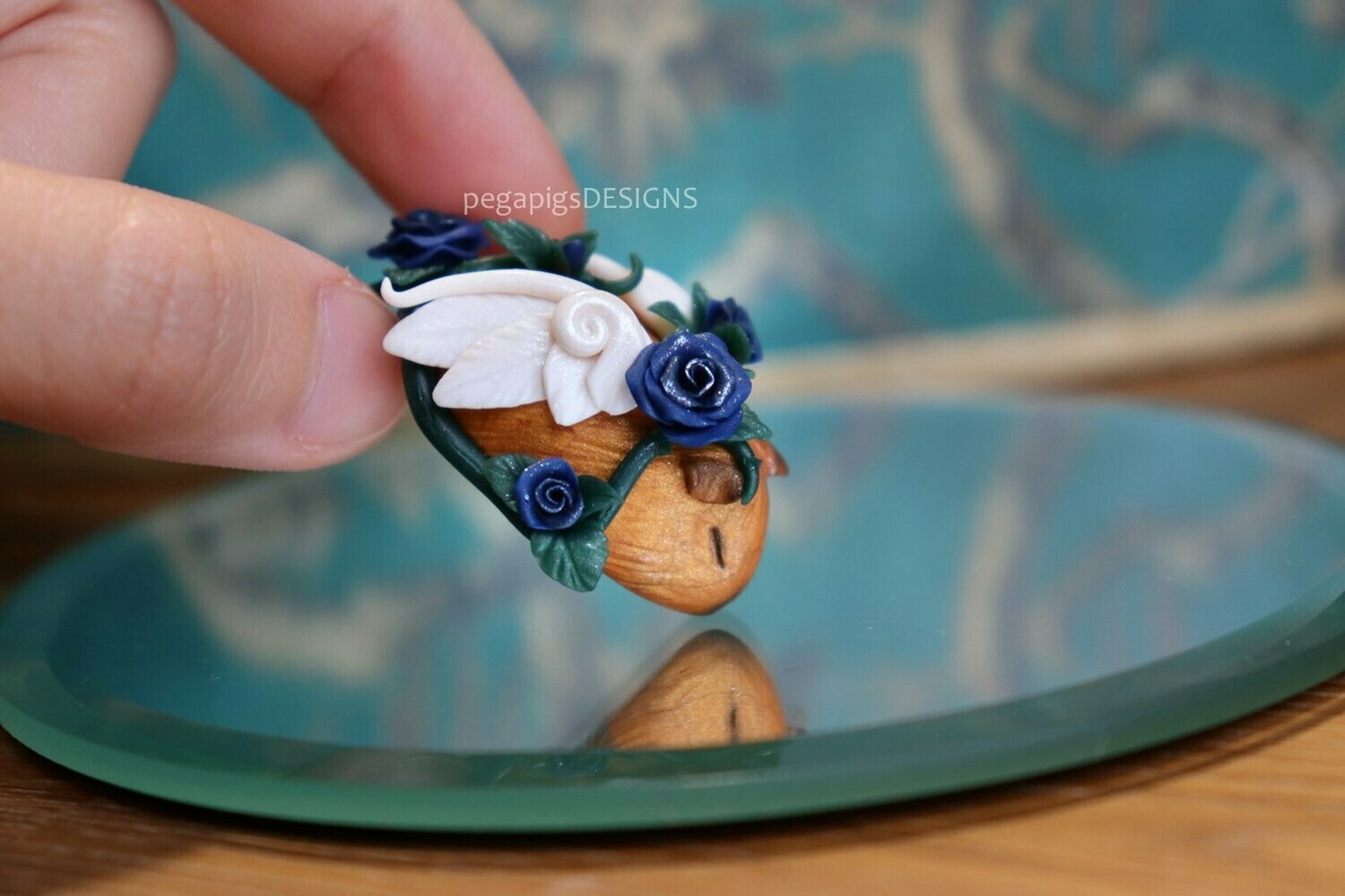 Small Sleeping Beauty Pegapiggy figurine with blue roses made with Fimo (guinea pig with wings)