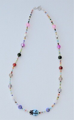 Handstrung Necklace with Glass Beads with Light Blue Ladybug.