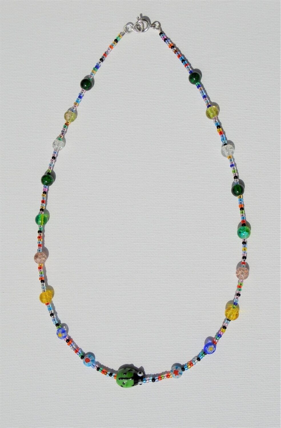 Handstrung Necklace with Glass Beads with Green Ladybug.