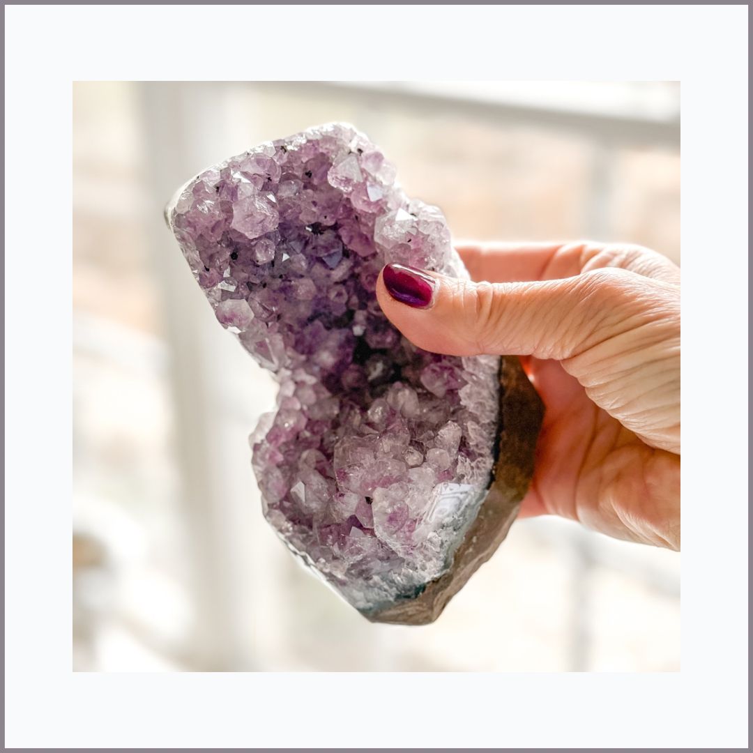 Amethyst geode half with natural crystal points