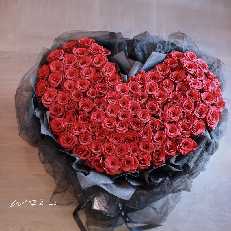 Heart-shaped red rose bouquet with soft chiffon wrapping
