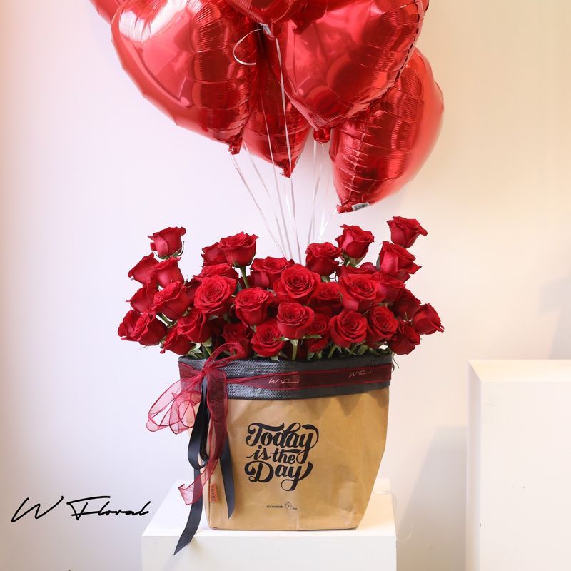 Grand red rose gift box with heart-shaped balloons by W Floral Studio Toronto