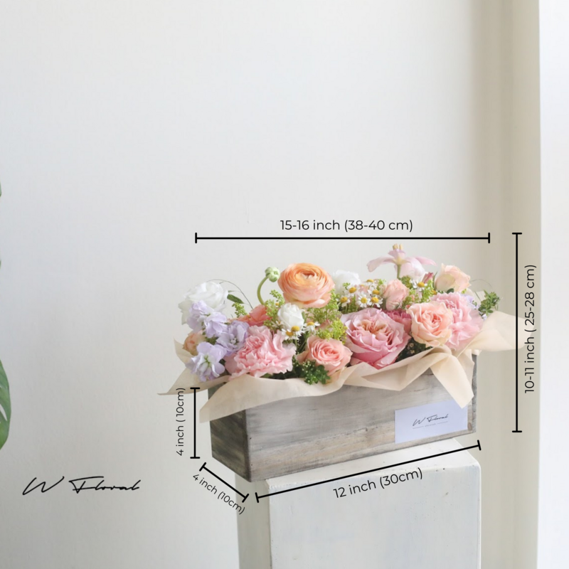 Pastel fresh flower box arrangement with roses and seasonal blooms