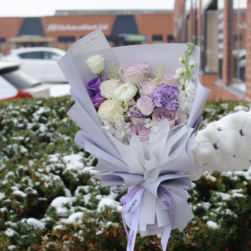 Pastel mixed flower bouquet with roses and seasonal blooms