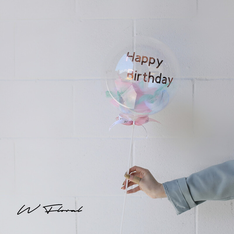 Personalized clear bubble balloon filled with pastel feathers