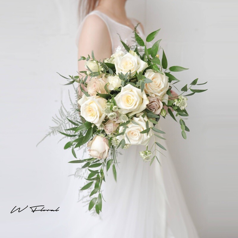 Romantic white cascading wedding bouquet with roses and greenery