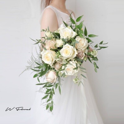 Romantic white cascading wedding bouquet with roses and greenery