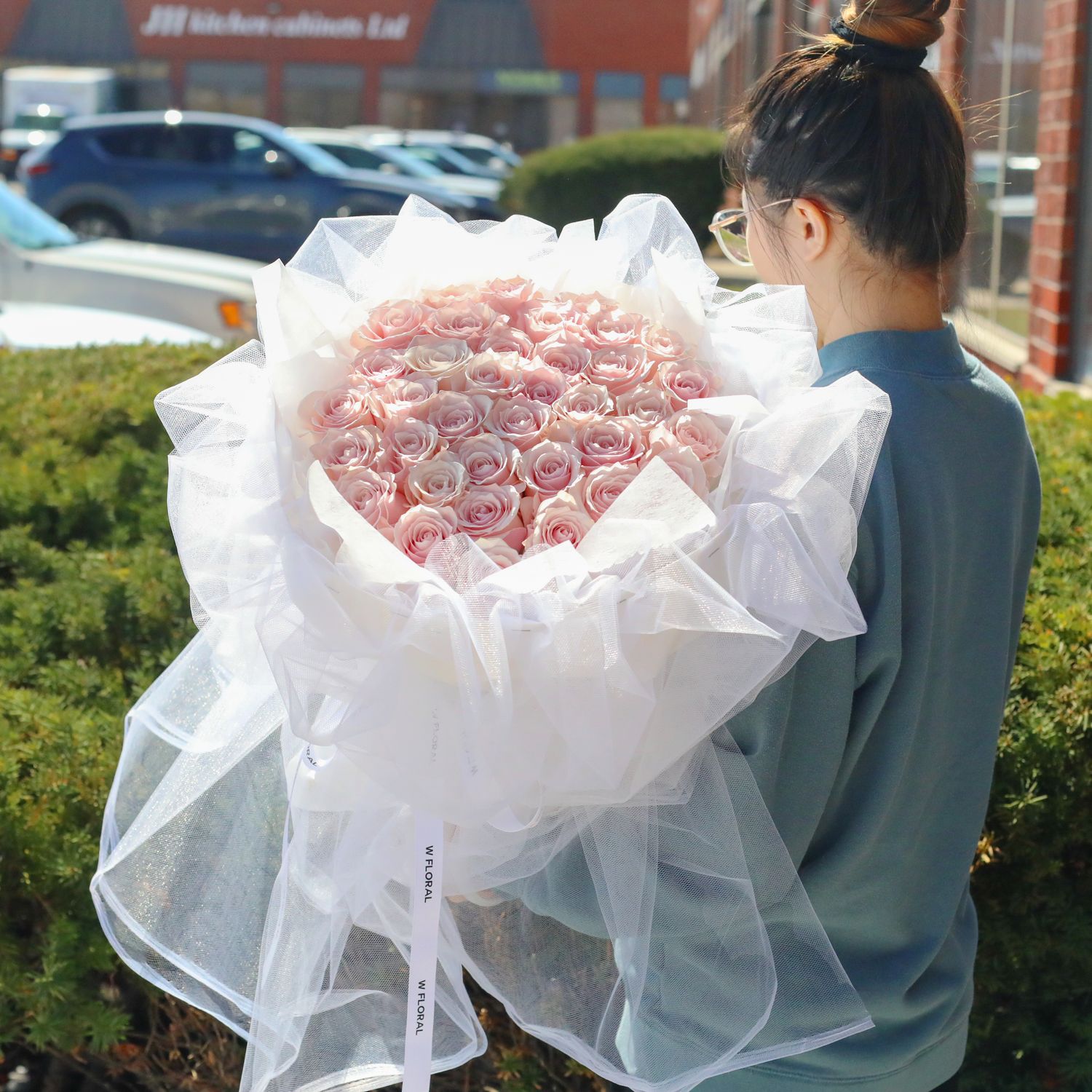 Soft pink rose bouquet wrapped in delicate white chiffon for romantic gifting