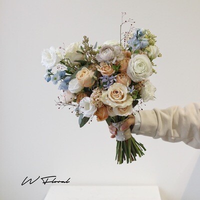 Natural bridal bouquet with roses seasonal blooms and greenery