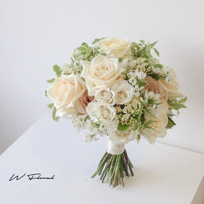 White ivory bridal bouquet with roses and seasonal flowers