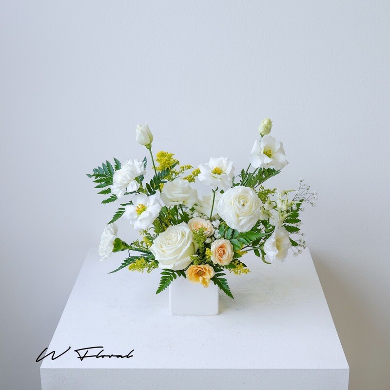Airy garden-style floral table centrepiece for wedding or event