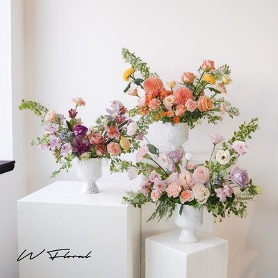 Colourful asymmetrical flower arrangement with seasonal blooms
