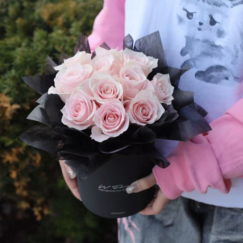 Pink roses arranged in black round flower box by W Floral Studio Toronto