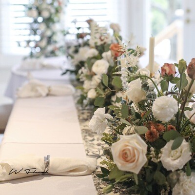 Low fresh flower wedding centrepiece with roses and greenery