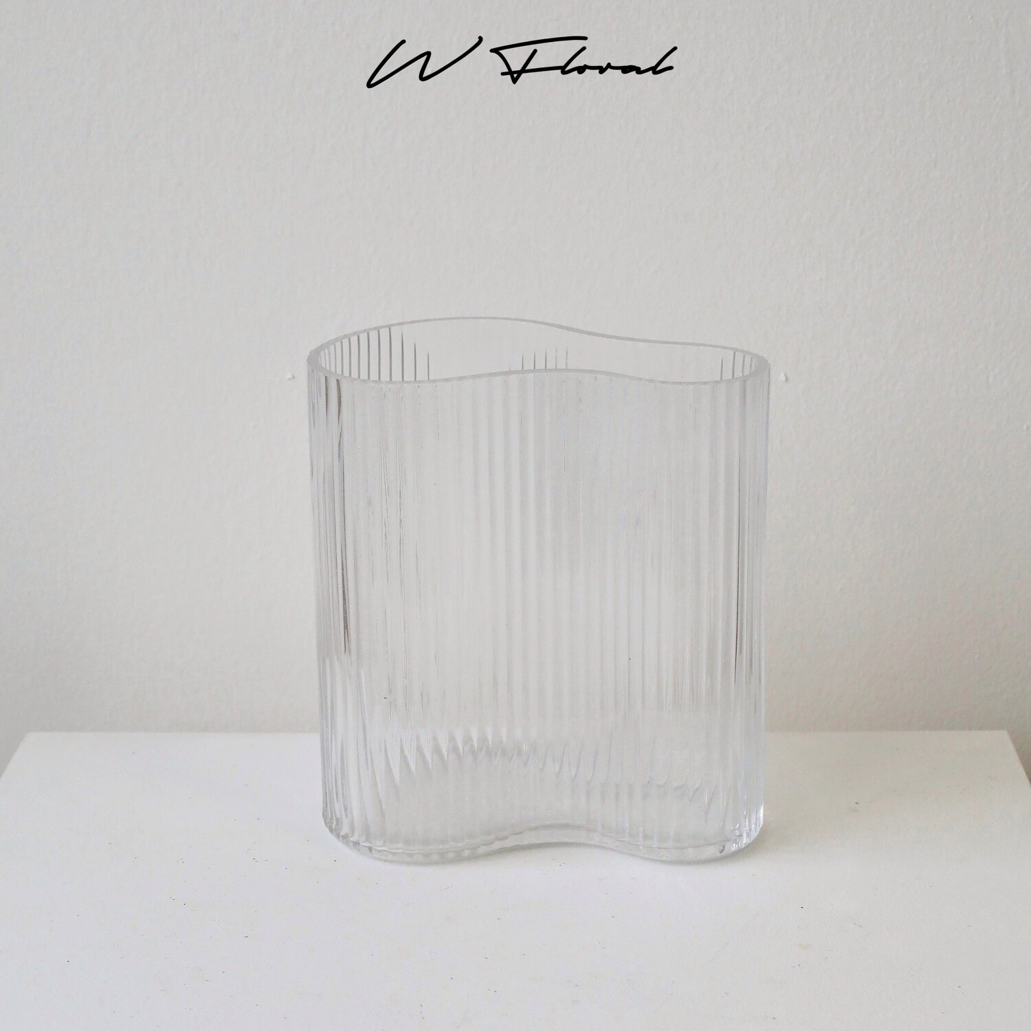 Modern clear ribbed vase with soft sculptural curved silhouette