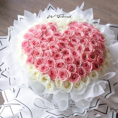 Luxury round rose bouquet featuring a pink rose heart design in the middle