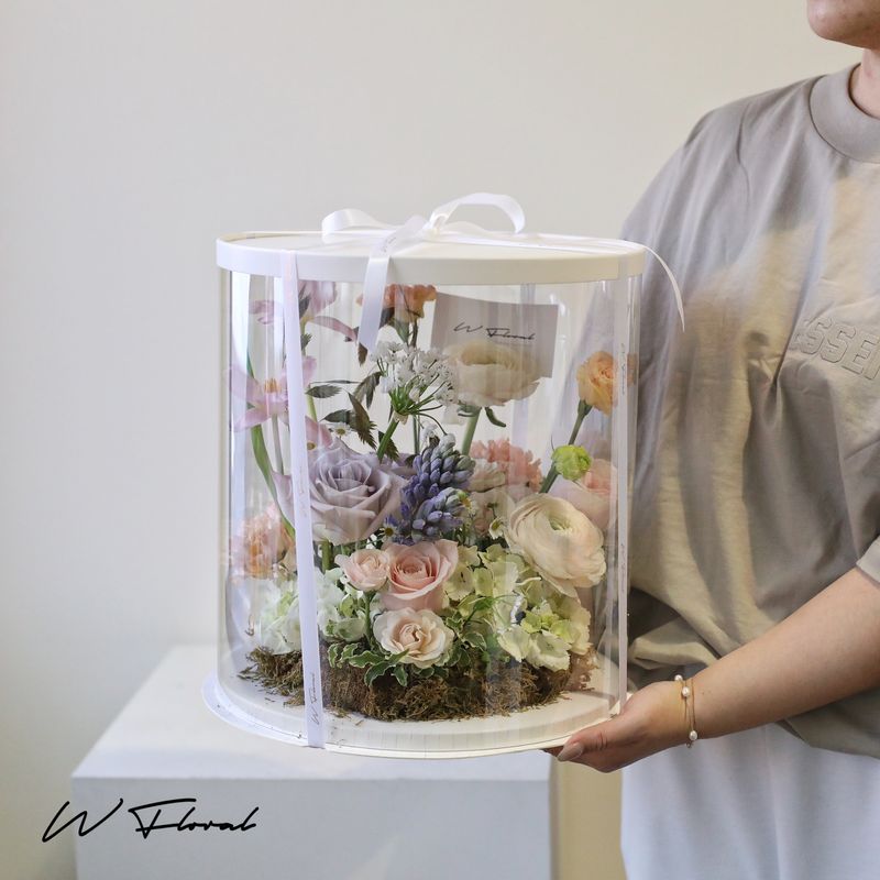 Clear flower box arrangement with fresh roses, ranunculus and pastel seasonal flowers by W Floral Studio Toronto