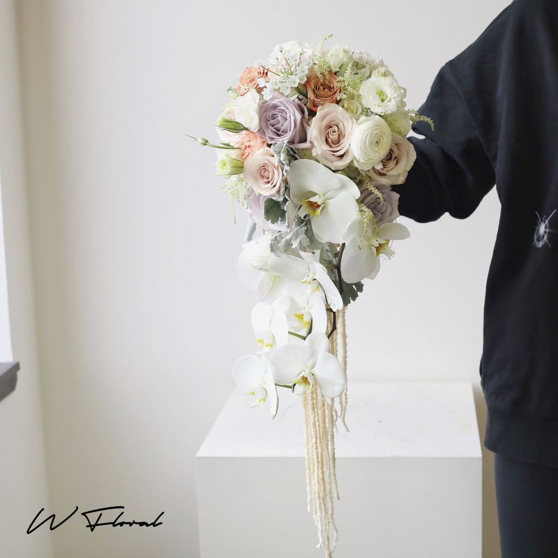 Luxury orchid wedding bouquet with roses and flowing details