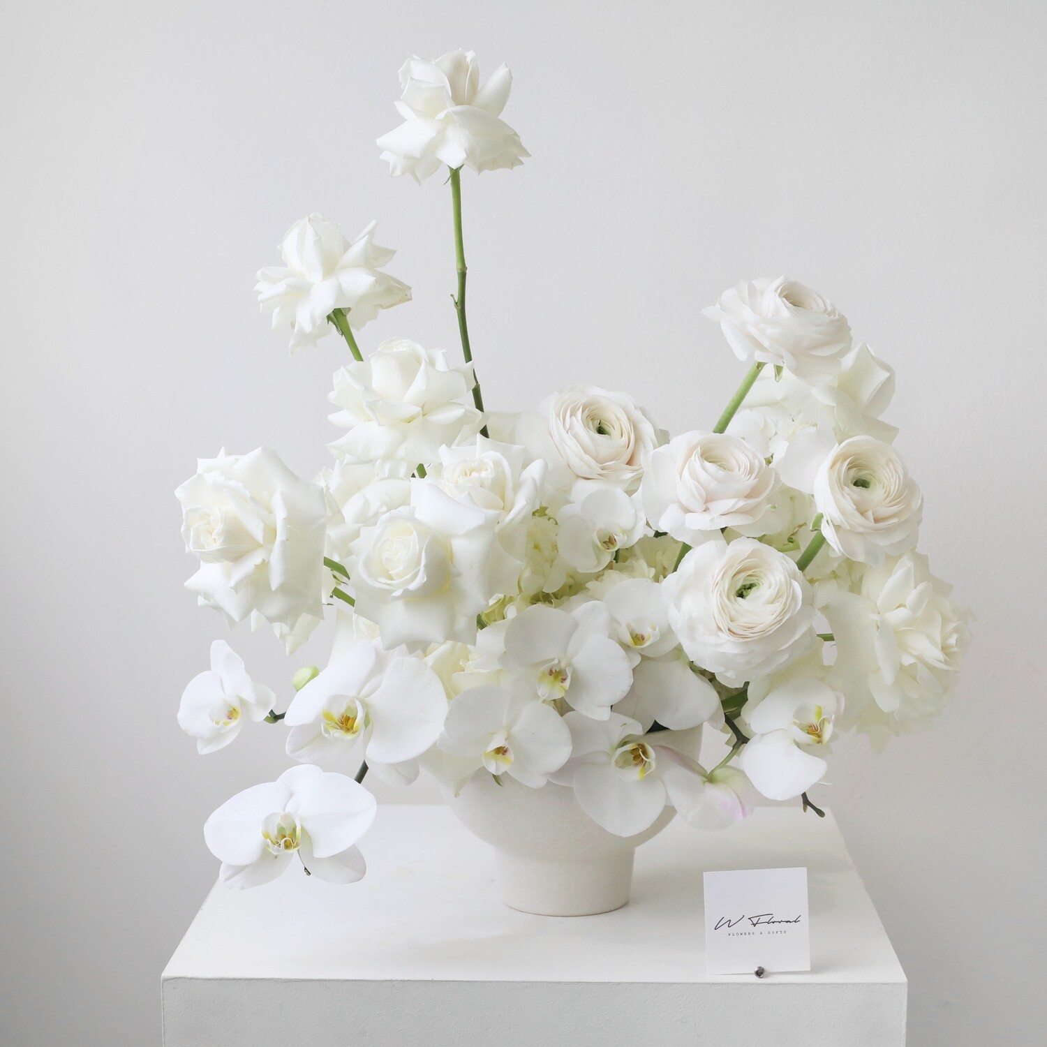 Luxury white statement flower arrangement with orchids, roses and premium seasonal blooms