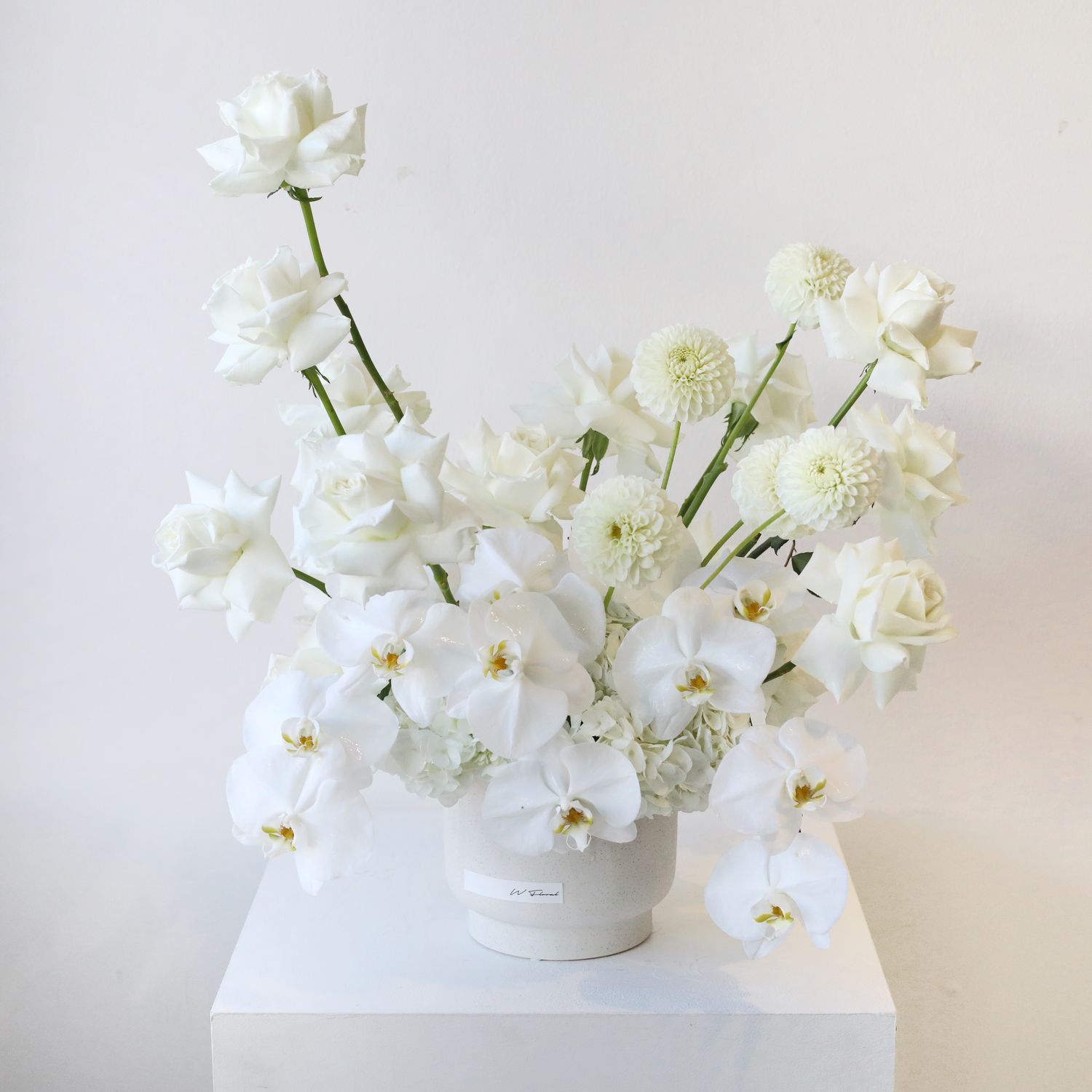 Luxury white statement flower arrangement with orchids, roses and premium seasonal blooms