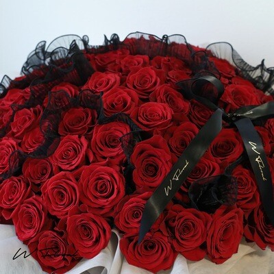 Premium red roses arranged in a classic round bouquet for romantic gifting