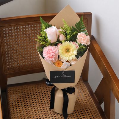 Small flower bouquet with roses gerbera and seasonal blooms