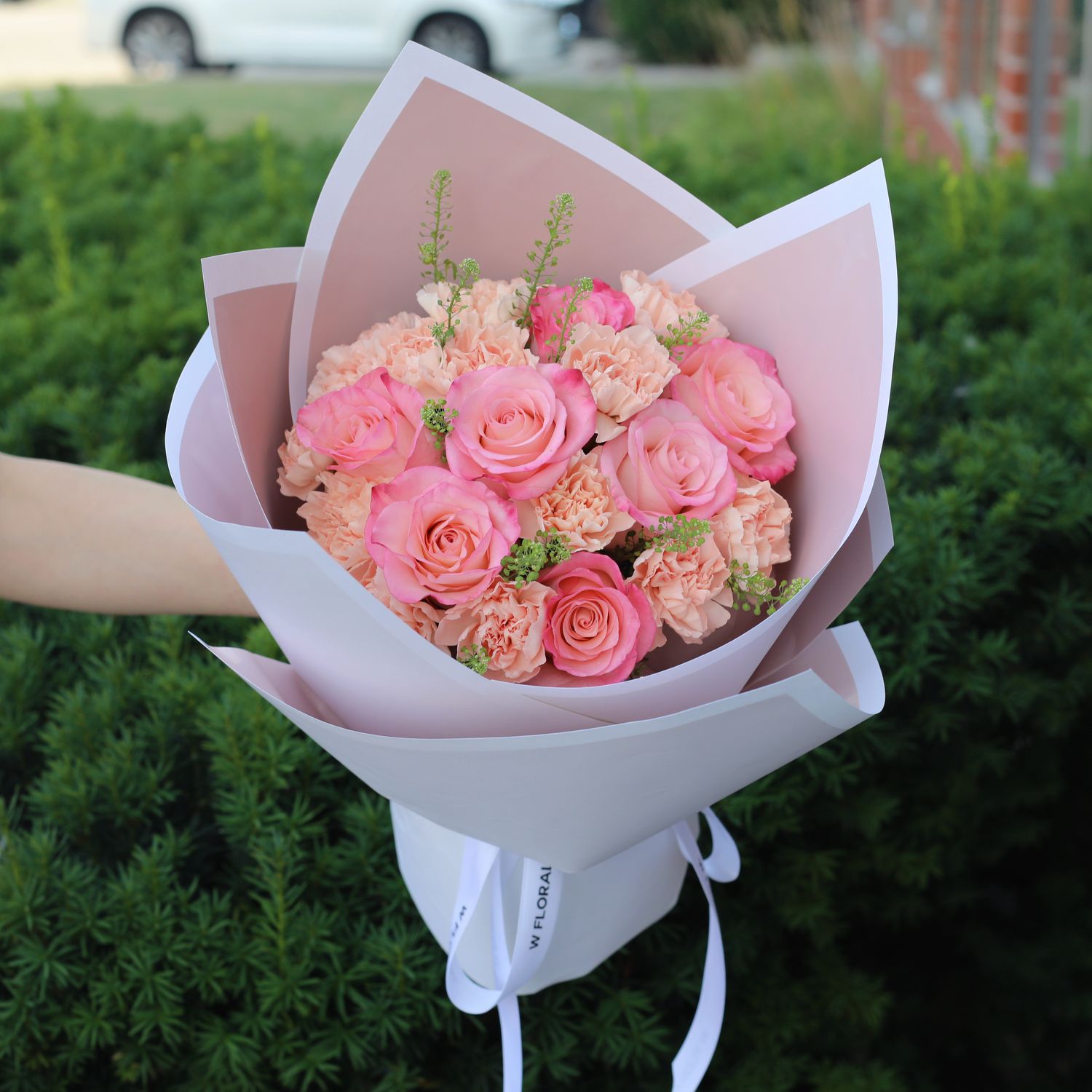 Peach carnation and pink rose bouquet by W Floral Studio