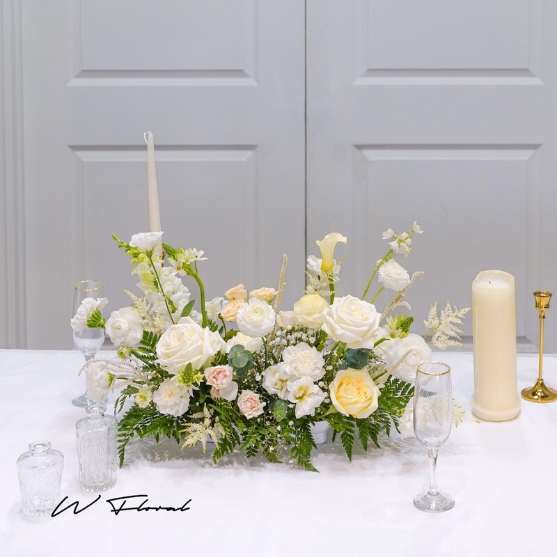 Extended garden-style wedding centrepiece with cream and white fresh flowers