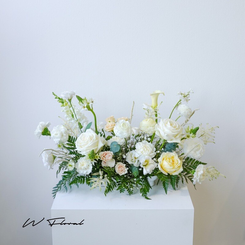 Long cream and white wedding centrepiece for head table and signing table