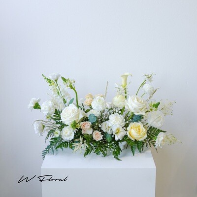 Long cream and white wedding centrepiece for head table and signing table