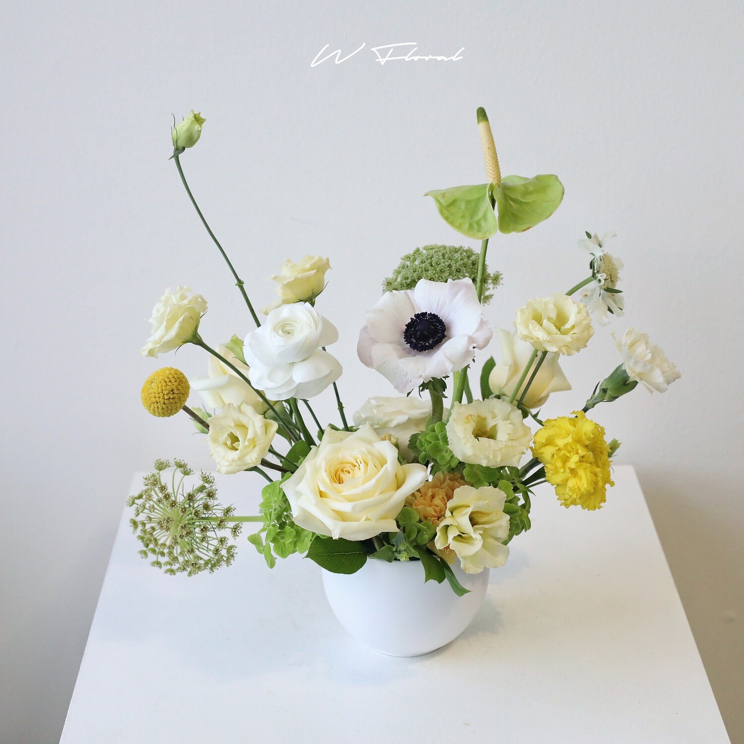 Low seasonal floral centrepiece in round white vessel Toronto