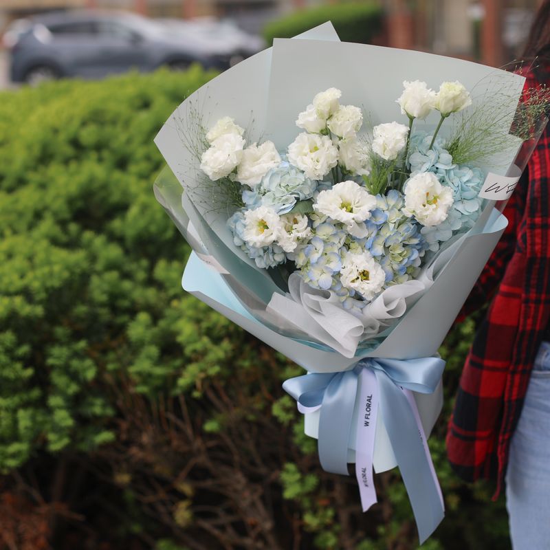 Blue hydrangea and white lisianthus bouquet by W Floral Studio