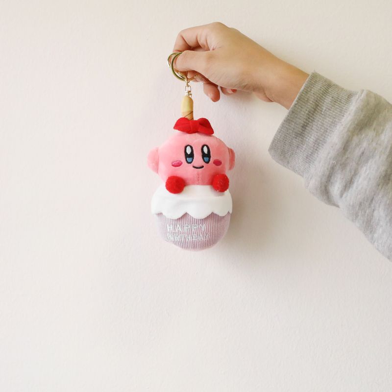 Kirby birthday plush keychain held for size reference