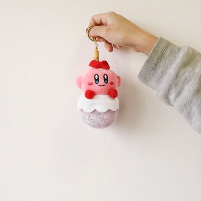 Kirby birthday plush keychain held for size reference