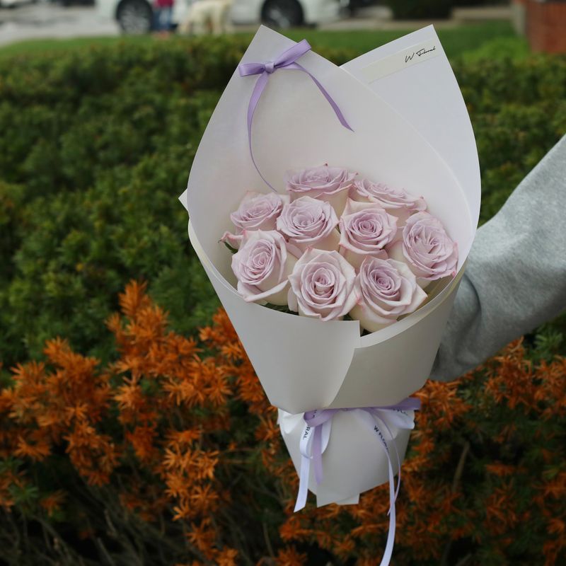 Romantic lavender rose bouquet arranged in an elegant round style