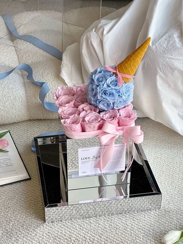 Blush pink and pastel blue preserved flower cake arrangement