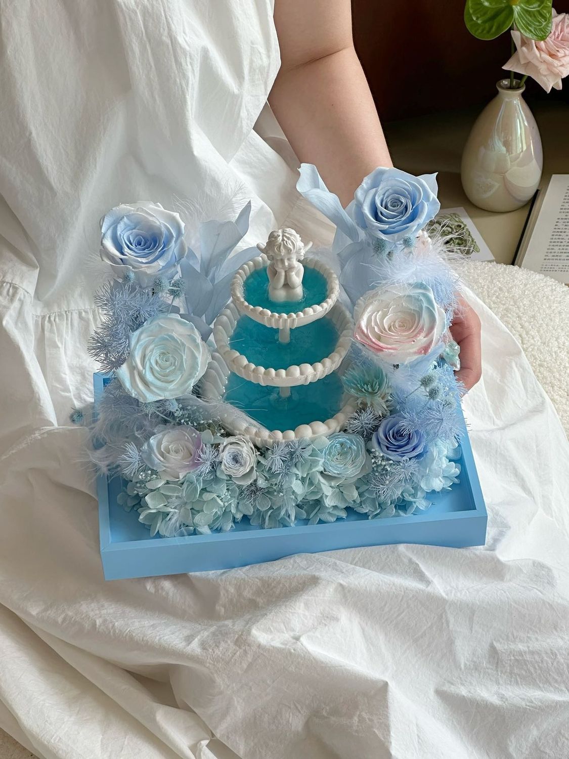 Ice blue preserved flower arrangement with dreamy sculptural design