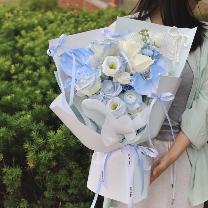 Sora blue white bouquet with lisianthus orchids and roses