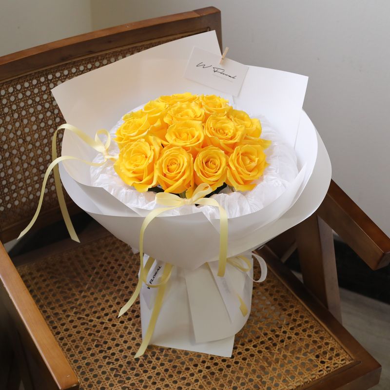 Bright yellow rose bouquet arranged in a charming round shape