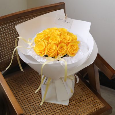 Bright yellow rose bouquet arranged in a charming round shape