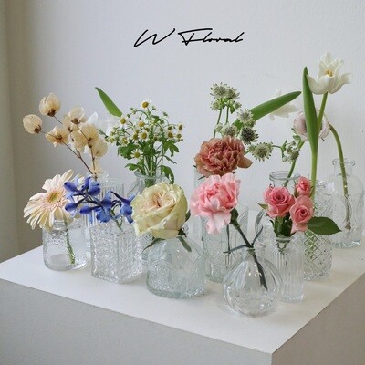 Artistic clear glass bud vase in a modern sculptural shape
