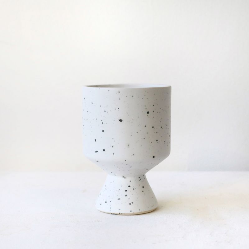 Modern speckled ceramic pedestal vase with matte white finish