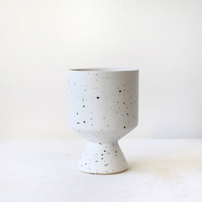 Modern speckled ceramic pedestal vase with matte white finish