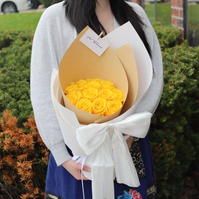 Silky Canelé yellow rose bouquet with elegant white ribbon bow