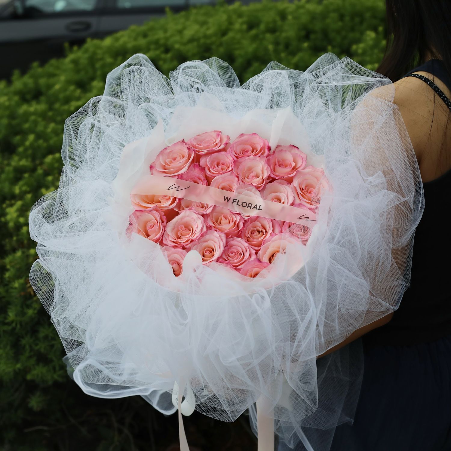 Soft pink Rhoslyn rose bouquet with elegant white chiffon wrapping