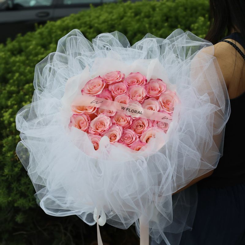 Soft pink Rhoslyn rose bouquet with elegant white chiffon wrapping