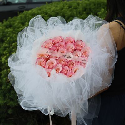 Soft pink Rhoslyn rose bouquet with elegant white chiffon wrapping