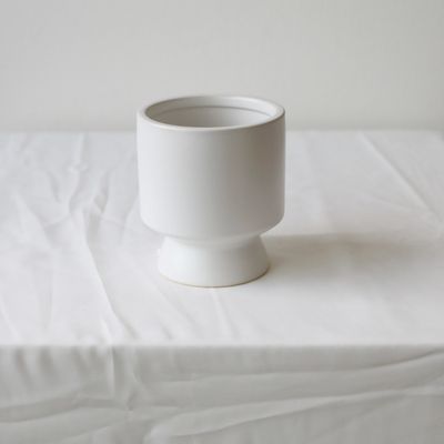 Modern white flower vase with clean sculptural pedestal design